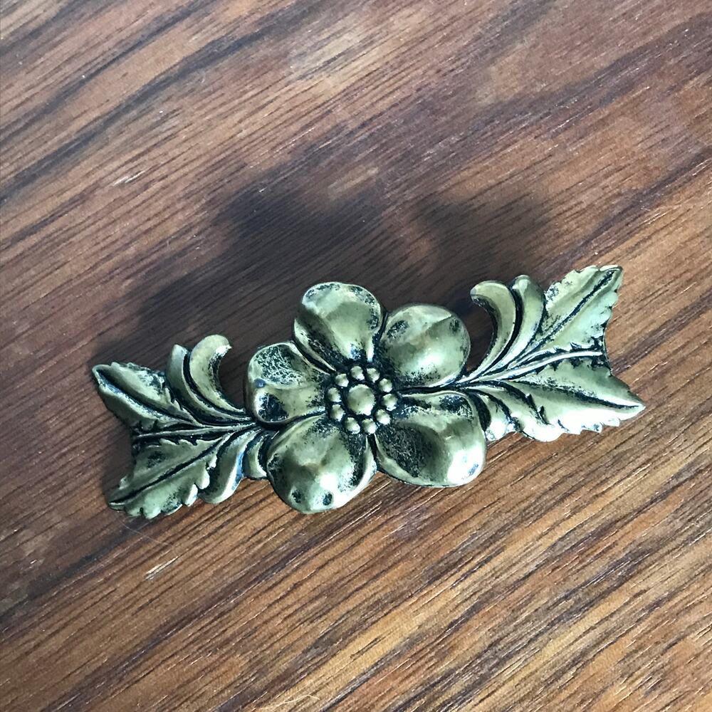 Floral brass tone accent pin, flower with leaves